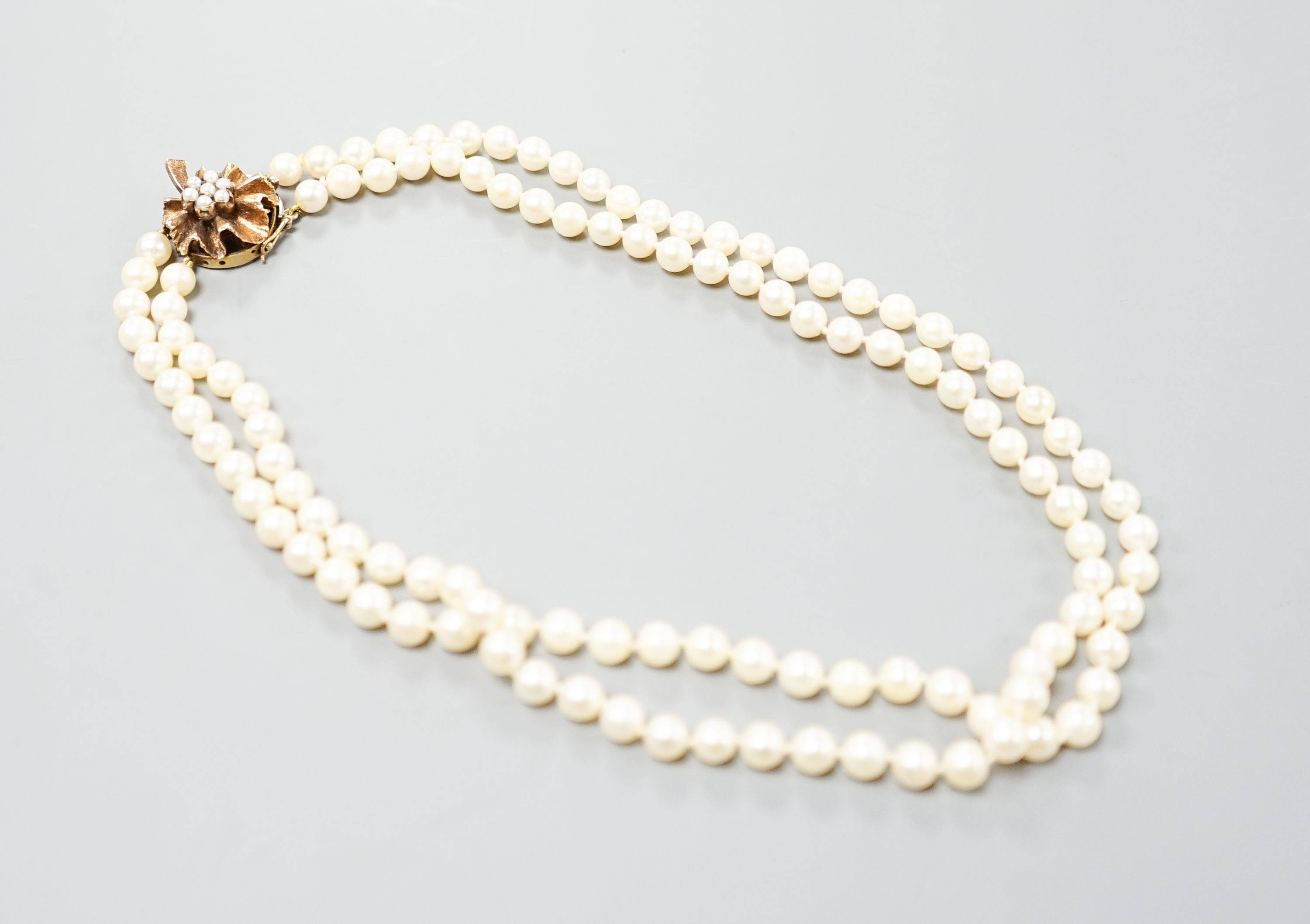 A double strand cultured pearl choker necklace, with cultured pearl set 9ct gold clasp, 38cm, with spare loose pearls.